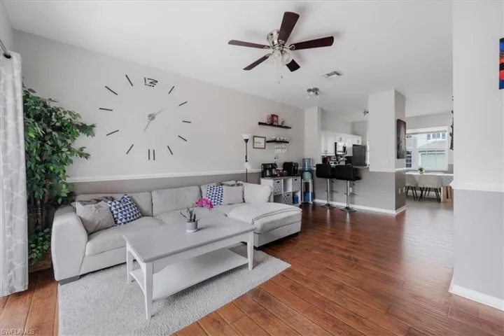 Living room with ceiling fan and wood-type flooring