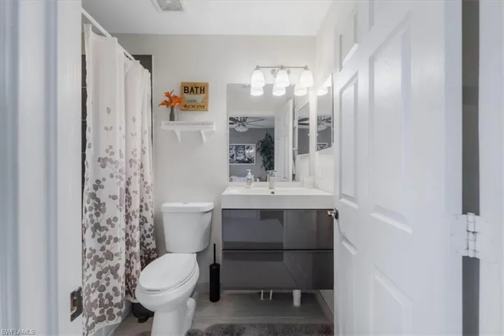 Bathroom featuring vanity, toilet, and hardwood / wood-style floors