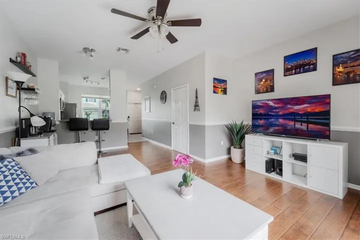 Living room featuring ceiling fan and light wood-type flooring