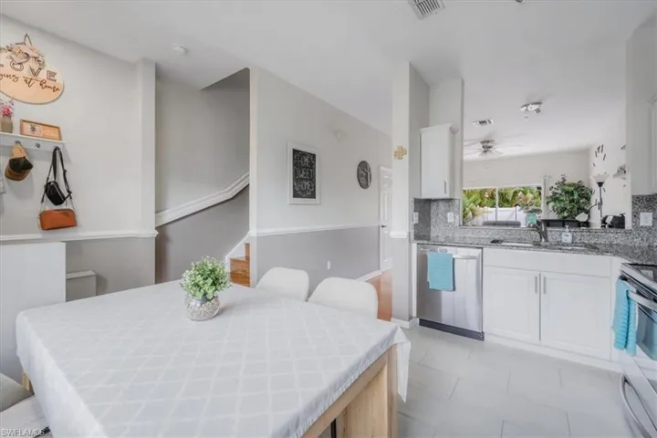 Tiled dining room featuring sink and ceiling fan