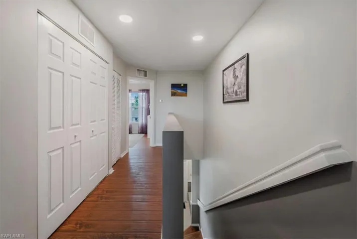 Hall with dark wood-type flooring
