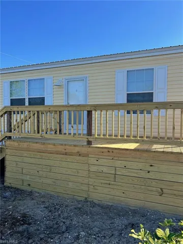 Back of property featuring a wooden deck