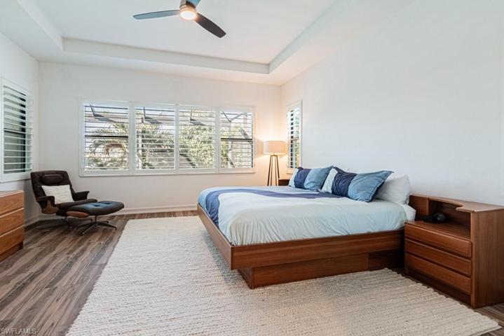 Main bedroom with plantation shutters,  tranquil views.