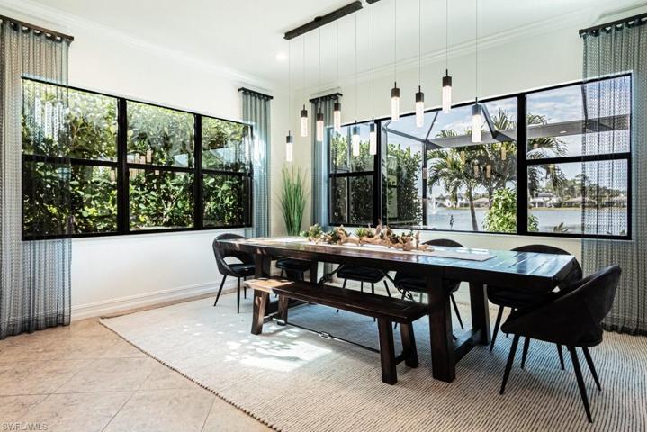 Dining area overlooking the pool, spa and lake.