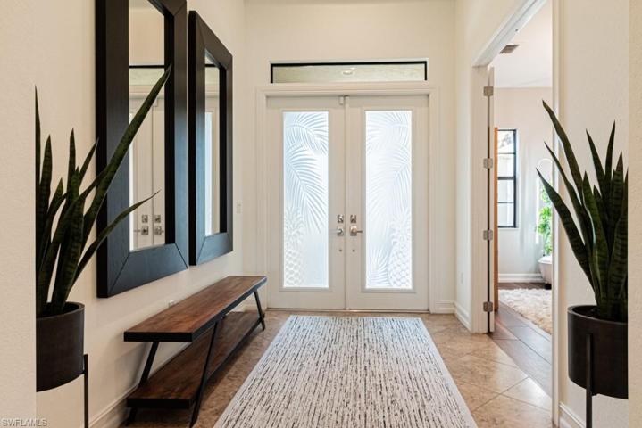 Double glass entry doors with welcoming foyer