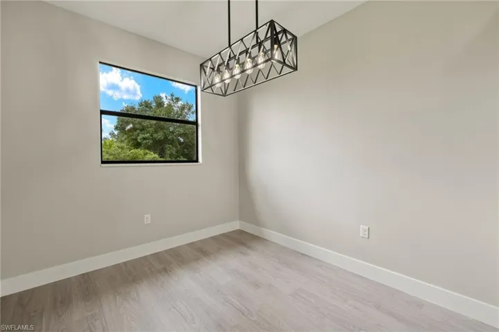 Empty room with light hardwood / wood-style flooring