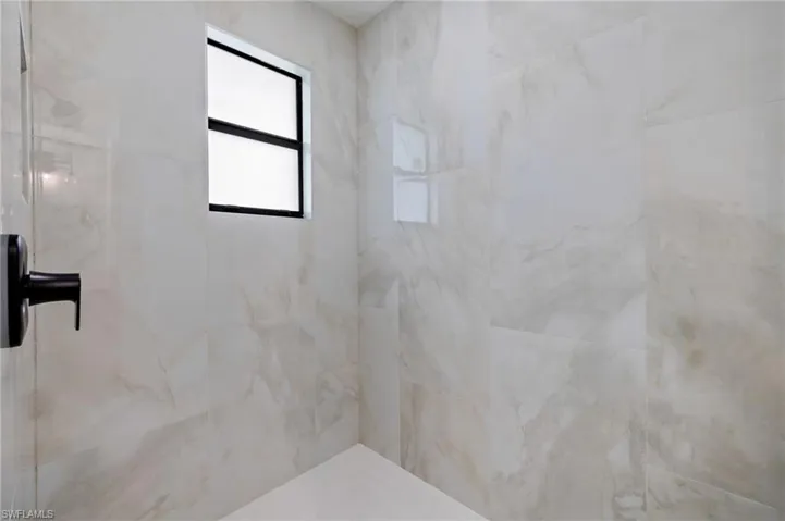 Bathroom featuring tiled shower