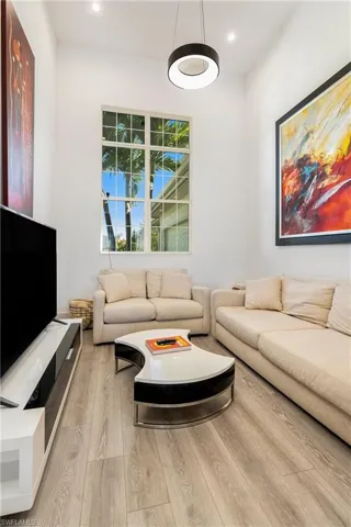 Living room with wood finished floors and recessed lighting
