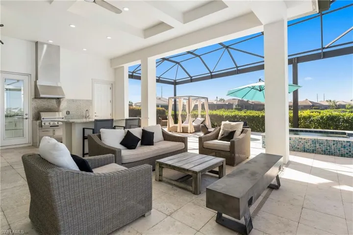 View of patio / terrace with an outdoor kitchen, a sunroom, glass enclosure, a ceiling fan, and a pool with connected hot tub