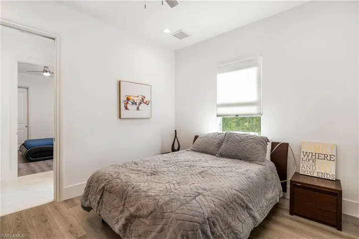 Bedroom with wood finished floors and baseboards
