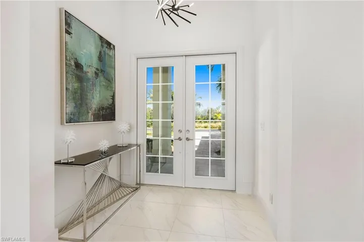 Doorway featuring french doors and marble look tile flooring