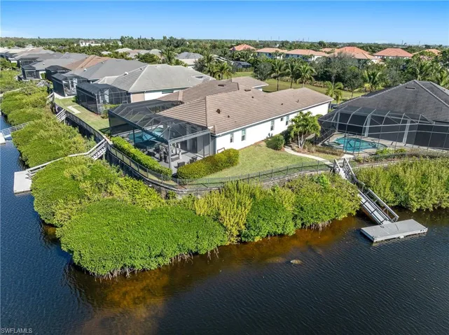 Aerial perspective of suburban area featuring a nearby body of water