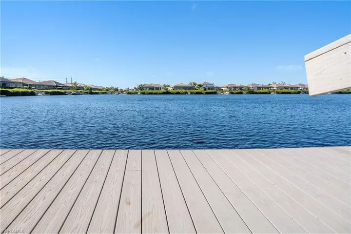 Dock with a residential view and a water view