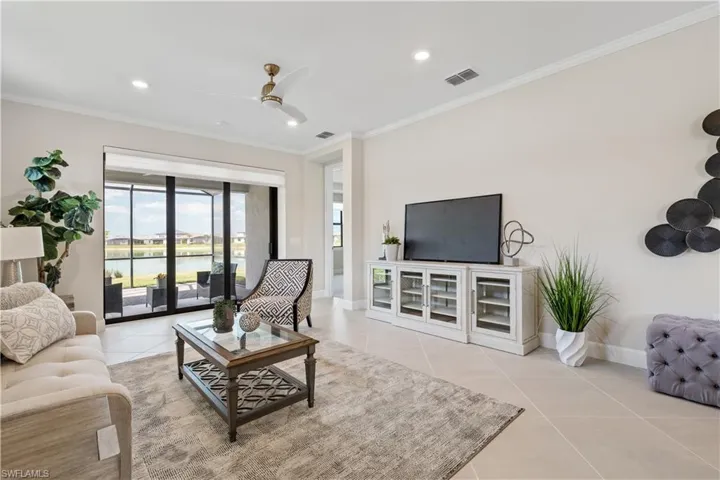 Spacious living area with designer fan and blinds.