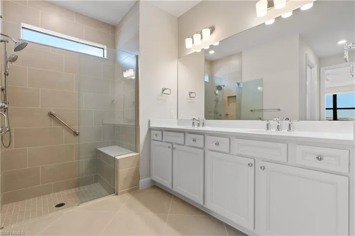 Primary bath with quartz counters, double sinks and walk in shower