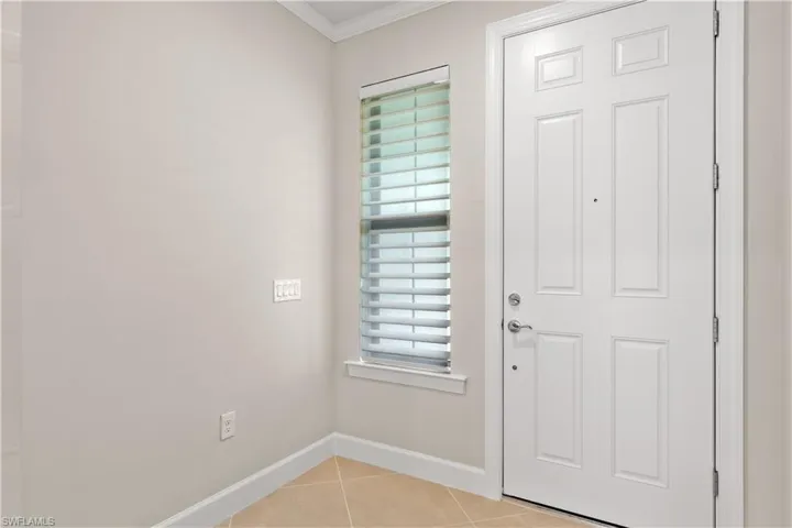 Foyer with silhouette blinds and closet