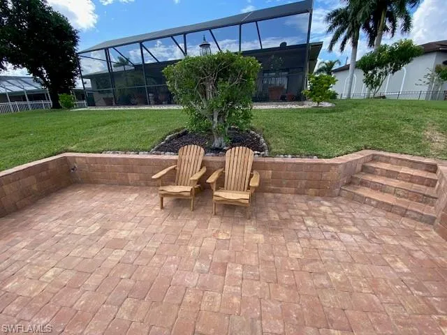 View of patio / terrace featuring a lanai and fence