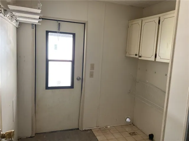 Utility room with washer and dryer hookup.