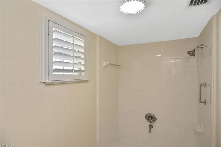 Bathroom with shower / washtub combination