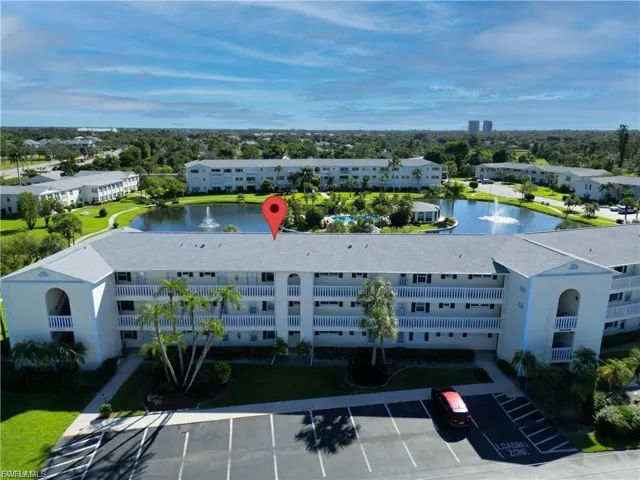Drone / aerial view of apartment complex and a large body of water
