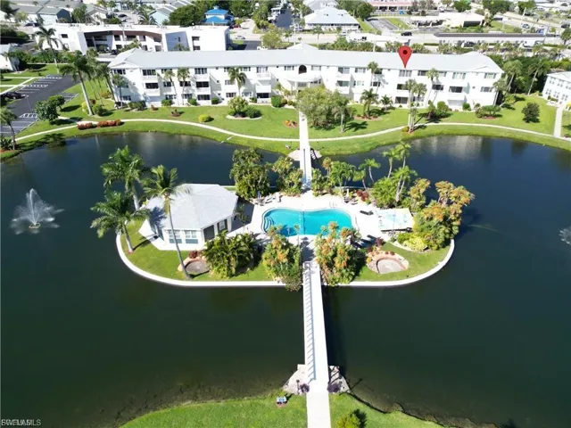 Bird's eye view of a nearby body of water and apartment complex / building