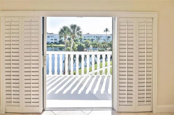 Doorway to outside featuring tile patterned floors and a water view