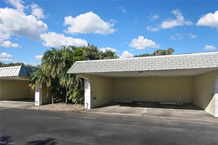 View of vehicle parking with an attached carport