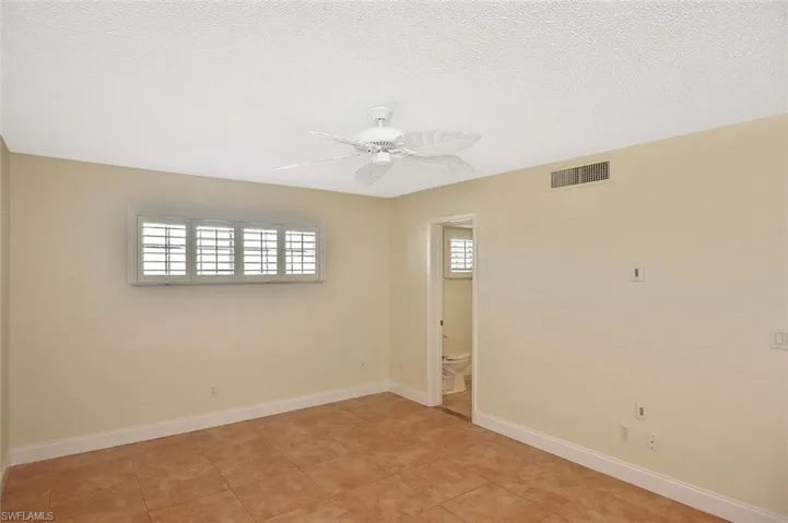 Unfurnished room featuring ceiling fan and a textured ceiling