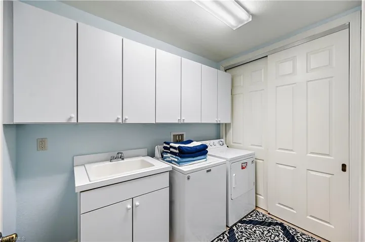 Laundry area with cabinet space and washer and dryer
