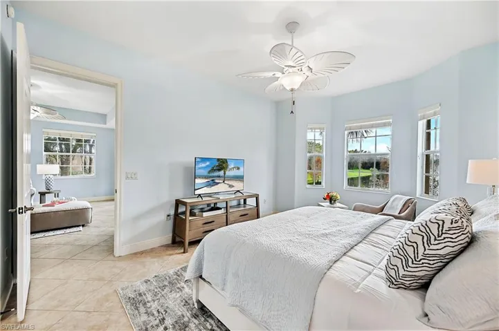 Bedroom with a ceiling fan and light tile patterned floors