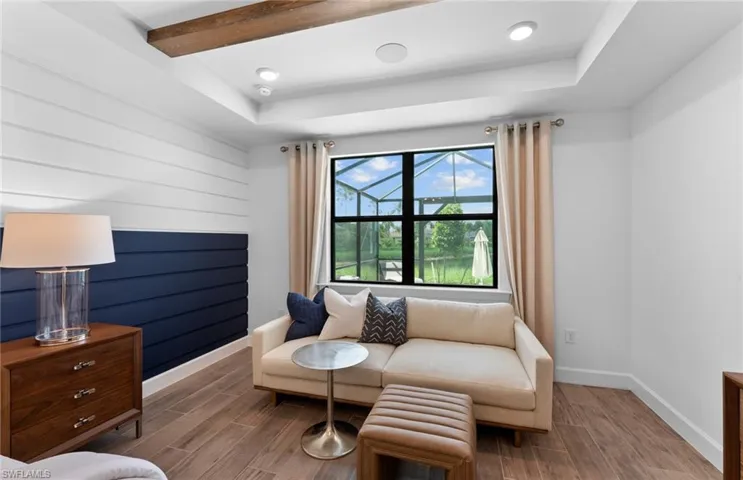 Sitting room featuring wood tiled floors, recessed lighting, and a raised ceiling