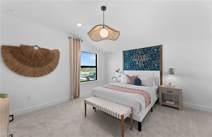 Bedroom featuring vaulted ceiling and light carpet