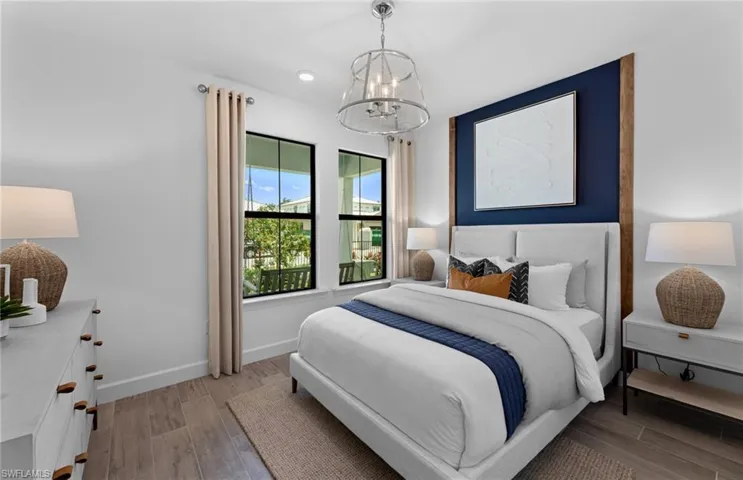 Bedroom featuring light wood finished floors and a chandelier
