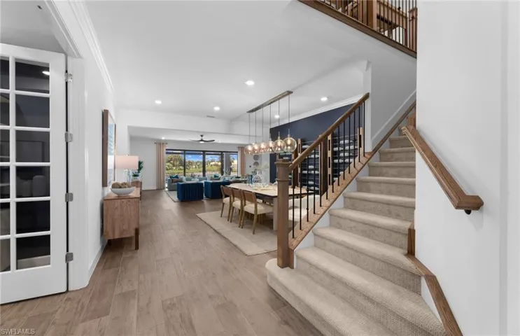 Stairway featuring wood finished floors, and recessed lighting