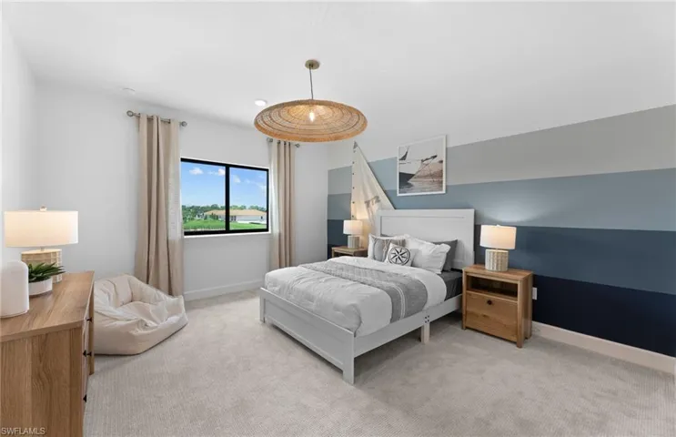 Bedroom featuring light colored carpet and baseboards