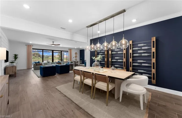 Dining space featuring wood finished floors, wine cooler, ornamental molding, a ceiling fan, and recessed lighting