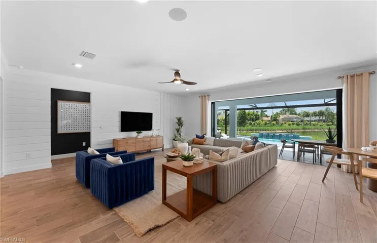 Living area with ceiling fan, wood tiled floors