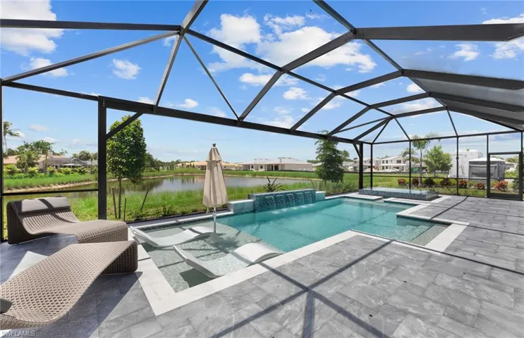 Outdoor pool with a lanai, a sunroom, a patio, a residential view, and a water view