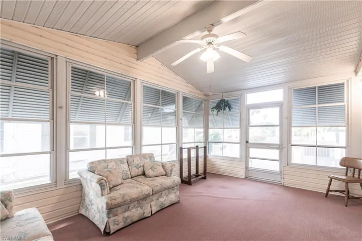 Sunroom / solarium with ceiling fan, carpet, and plenty of natural light