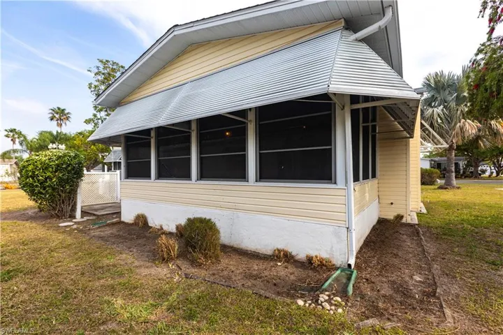 View of side of home featuring a lawn