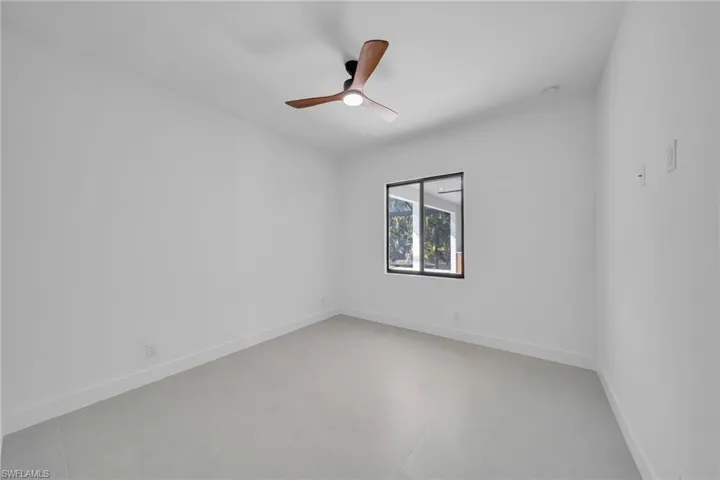 Empty room with baseboards and ceiling fan