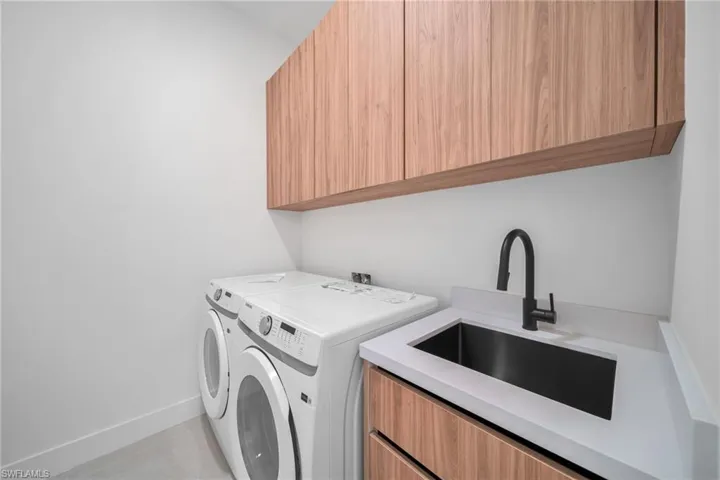 Laundry area with washing machine and clothes dryer and cabinet space