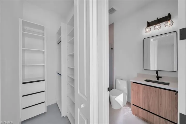 Bathroom with vanity and finished concrete floors