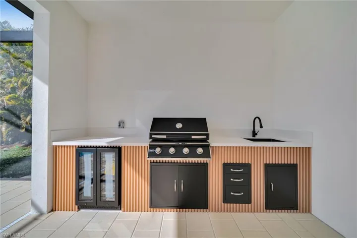 View of patio / terrace with beverage cooler and area for grilling