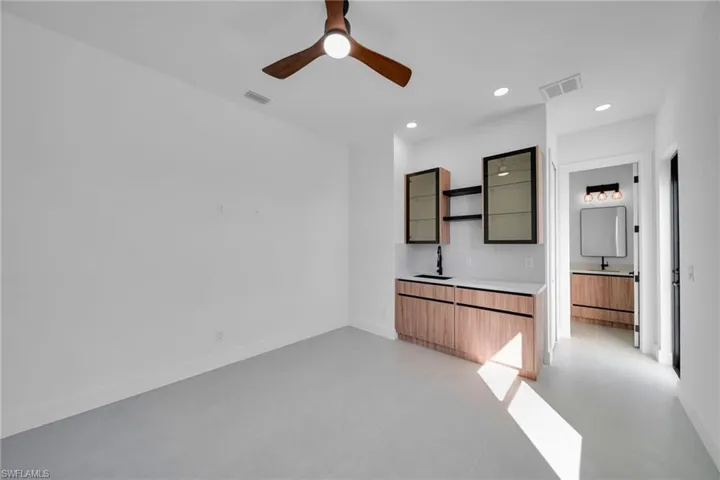 Unfurnished room featuring concrete flooring, a ceiling fan, and recessed lighting