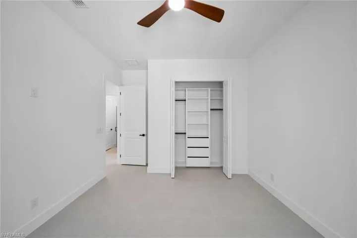 Unfurnished bedroom featuring a ceiling fan and a closet