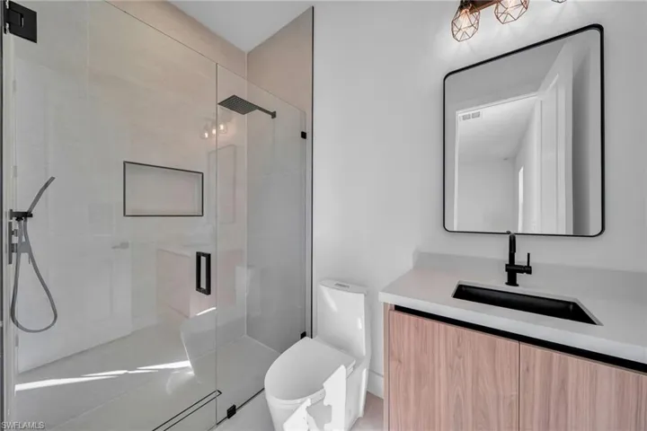 Full bathroom with vanity and a stall shower