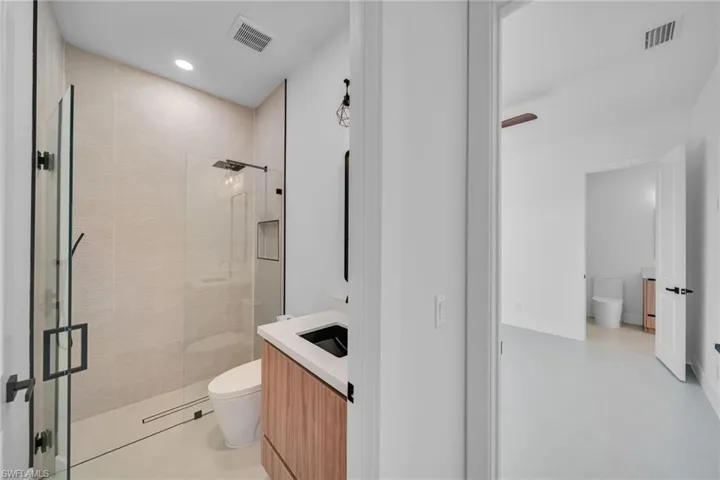 Full bath featuring vanity, a stall shower, and recessed lighting