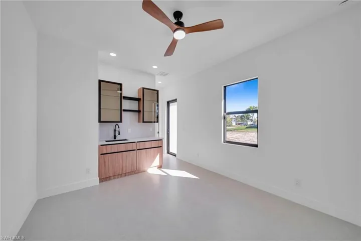 Unfurnished living room featuring a ceiling fan and recessed lighting
