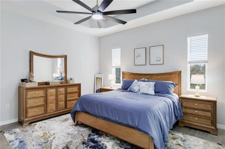 Bedroom featuring ceiling fan and light hardwood / wood-style flooring